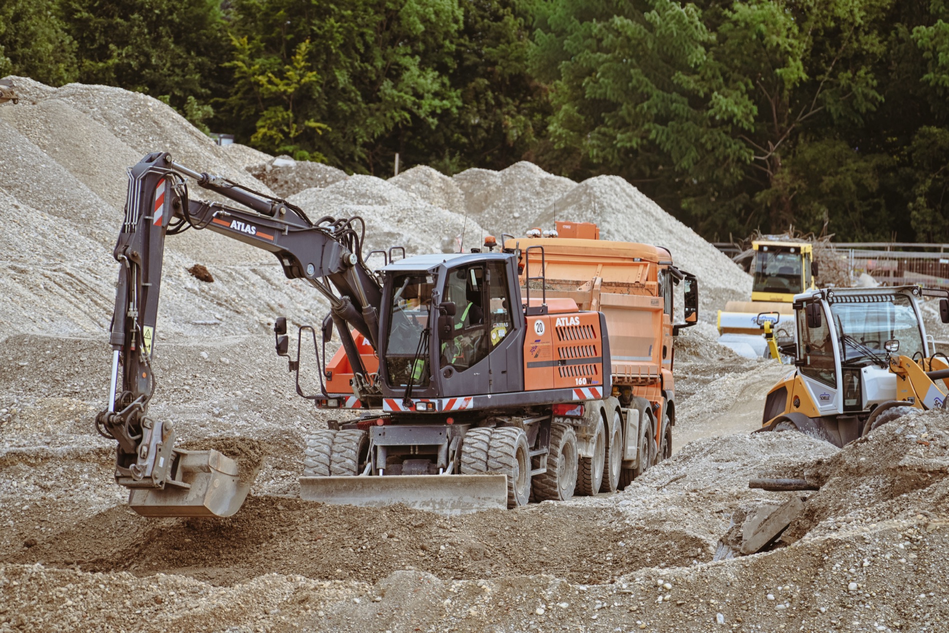 Excavator and dump truck on a gravel site